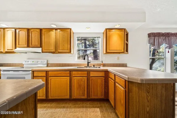a kitchen with stainless steel appliances granite countertop a sink and a stove