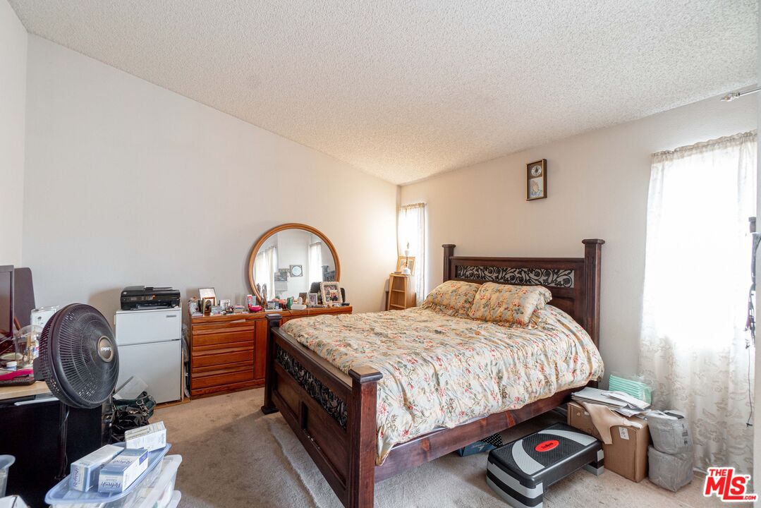 724 Anzac Circle Compton, CA 90220 - Photo 11 of 16 a bedroom with a bed a mirror and dresser