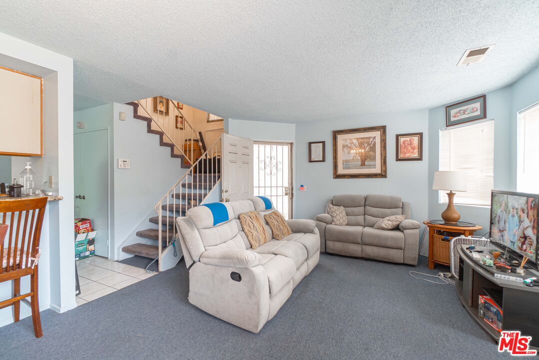 724 Anzac Circle Compton, CA 90220 - Photo 5 of 16 a living room with furniture and a flat screen tv
