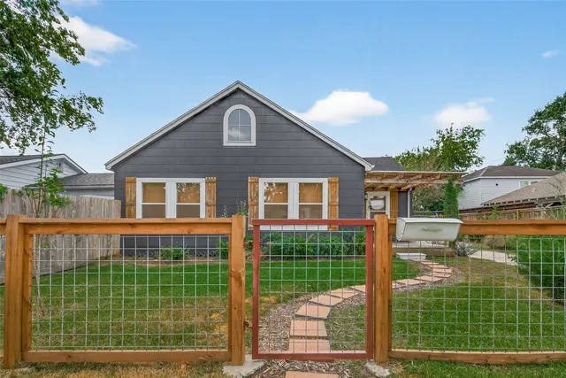 a front view of a house with a garden