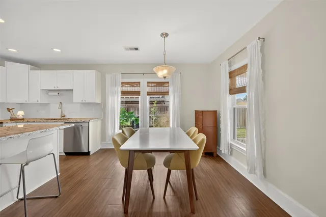 a large kitchen with kitchen island a large counter top stainless steel appliances and cabinets