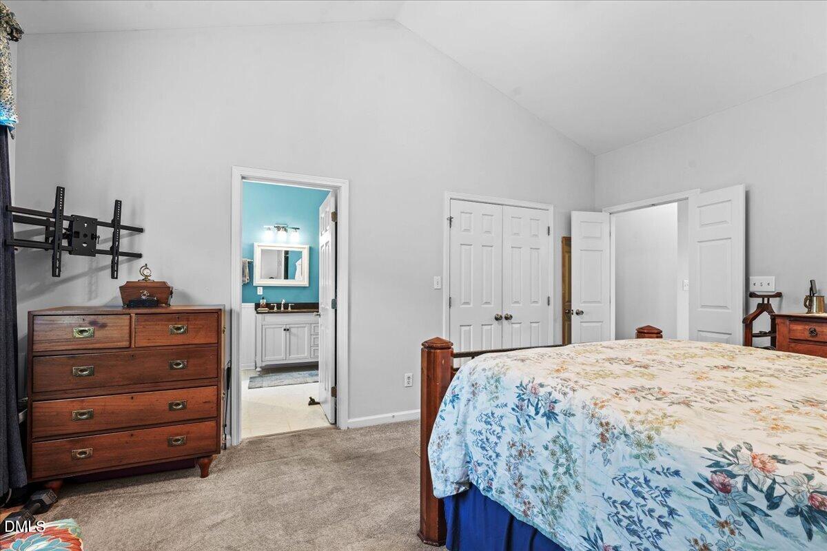 3331 Swinford Court Raleigh, NC 27604 - Photo 16 of 27 a bedroom with a bed and a dresser