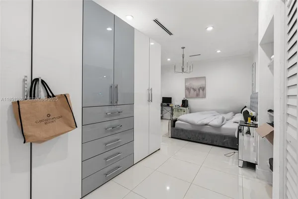 a spacious bedroom with a bed and a couch