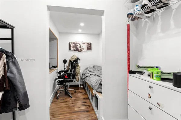 a living room with furniture a piano and a window