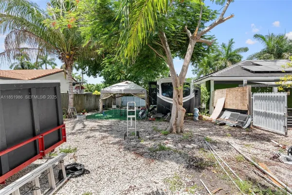 a bedroom with a bed and a flat tv screen on the wall