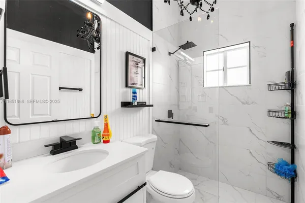 a kitchen with a refrigerator and white cabinets