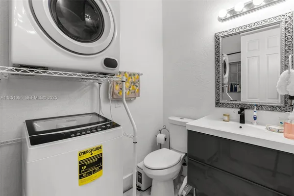 an aerial view of a house with a yard and large trees