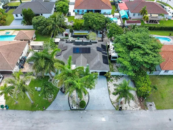 an aerial view of a house with garden space and street view