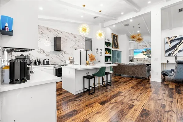 a living room with lots of furniture and a wooden floor
