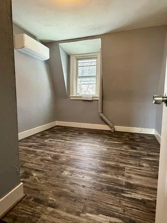 a view of a room with wooden floor and cabinet