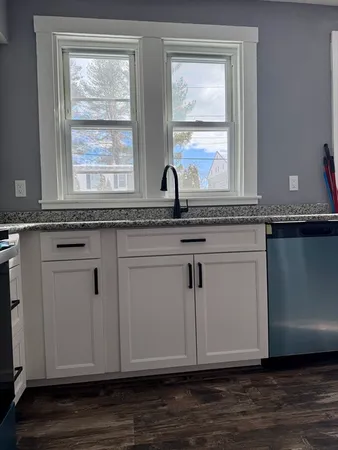 a view of cabinets with wooden floor and window