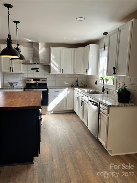 1415 Miles Road Dallas, NC 28034 - Photo 11 of 23 a kitchen with stainless steel appliances granite countertop a stove a sink and a microwave