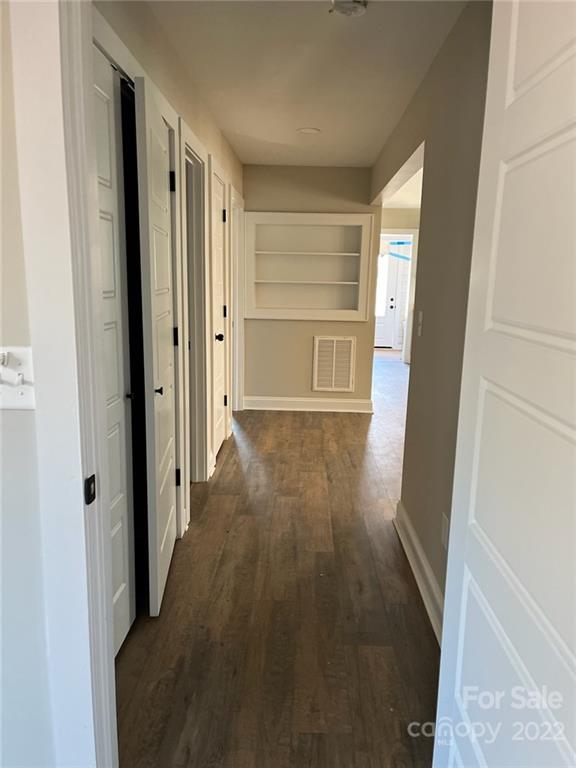 1415 Miles Road Dallas, NC 28034 - Photo 17 of 23 a view of a hallway with wooden floor and closet area