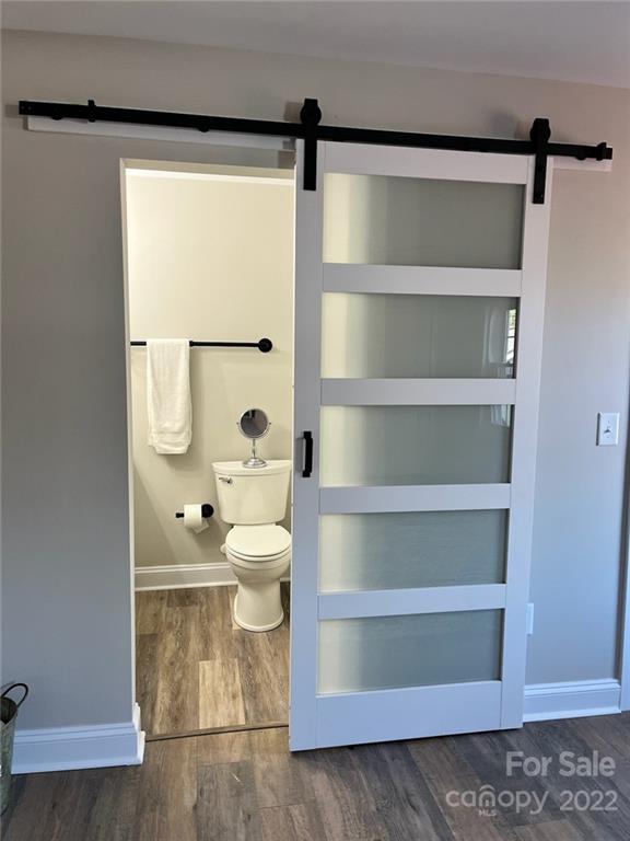 1415 Miles Road Dallas, NC 28034 - Photo 21 of 23 a bathroom with a toilet a sink and shower