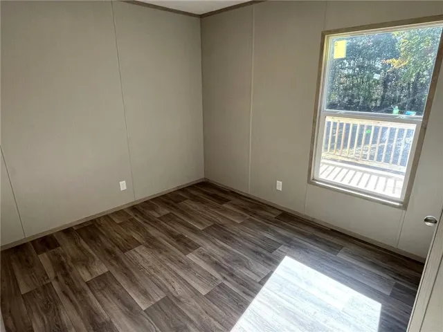 a view of a room with wooden floor and windows