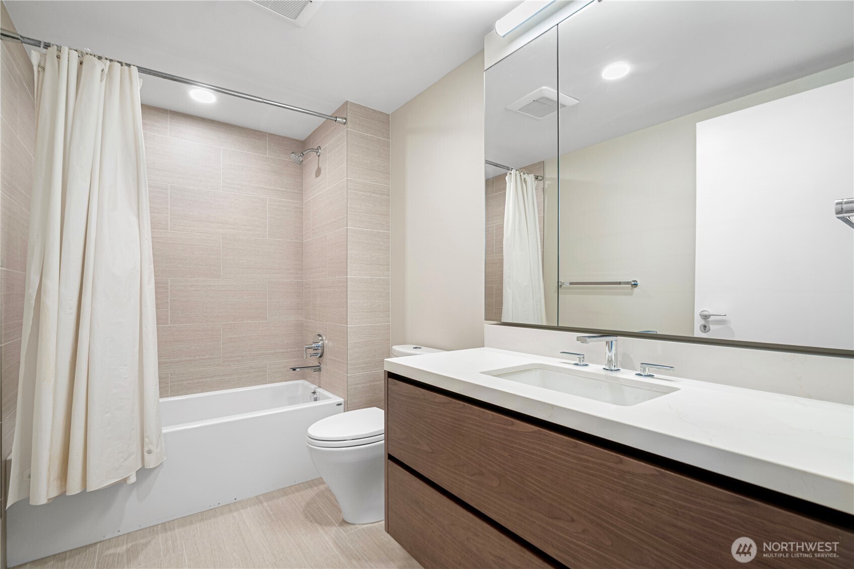 121 Stewart Street, Unit 1605 Seattle, WA 98101 - Photo 15 of 38 a bathroom with a sink a toilet and shower