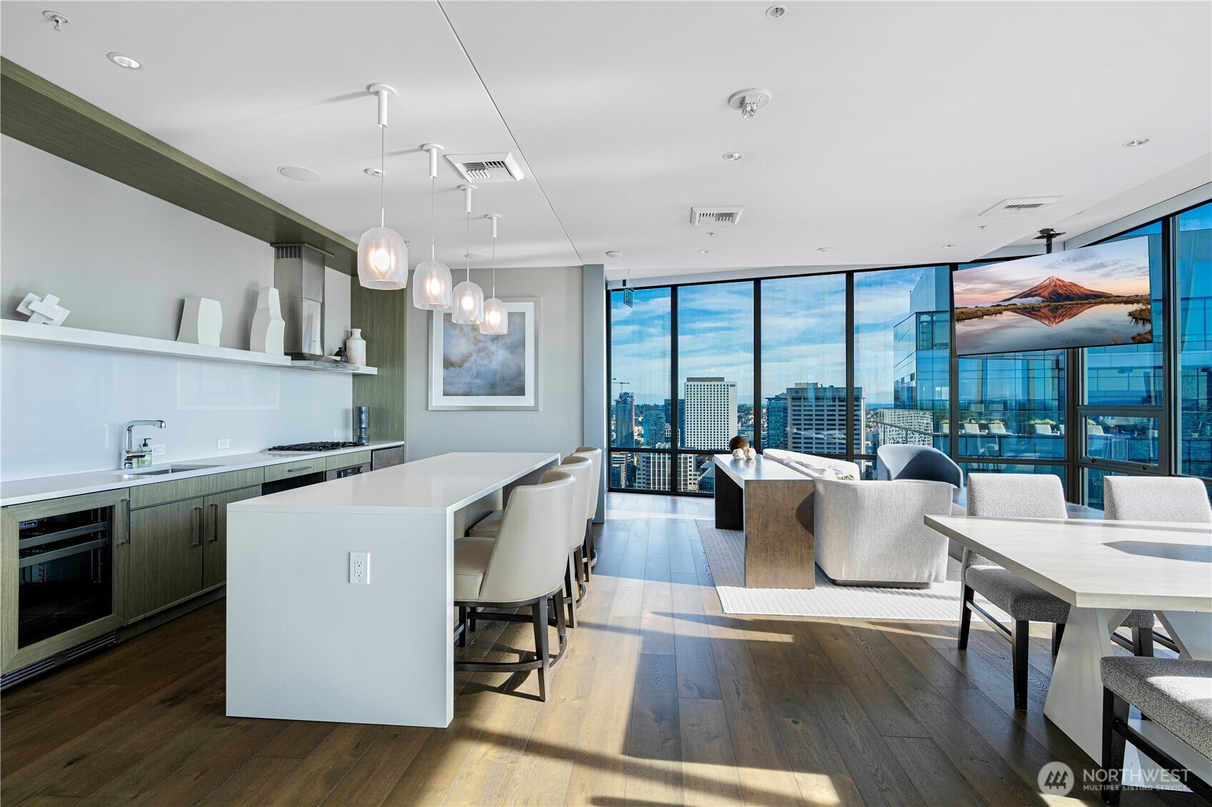 121 Stewart Street, Unit 1605 Seattle, WA 98101 - Photo 27 of 38 a living room with furniture a table and chairs next to a large window