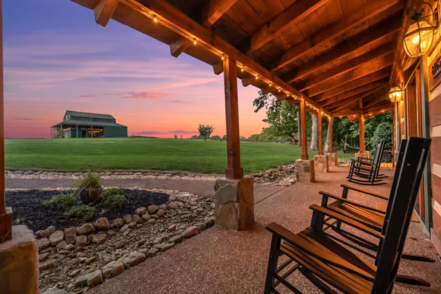 a view of a porch with furniture and yard