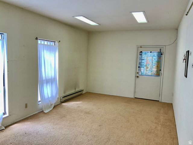 630 North Main Street Monroe, UT 84754 - Photo 46 of 63 Empty room in shop featuring light carpet and baseboard heating