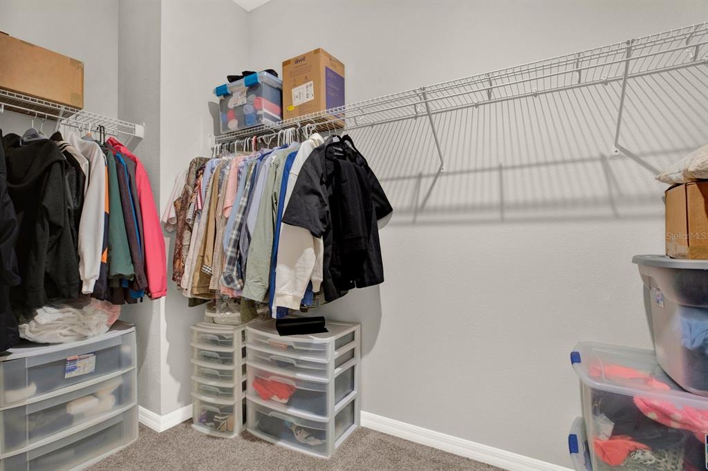 13729 Rangeland Boulevard Odessa, FL 33556 - Photo 21 of 30 a view of walk in closet with clothes and shoes