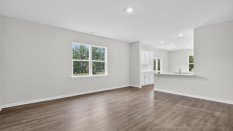 194 Fair Child Road Spring Lake, NC 28390 - Photo 13 of 33 a view of an empty room with wooden floor and a window