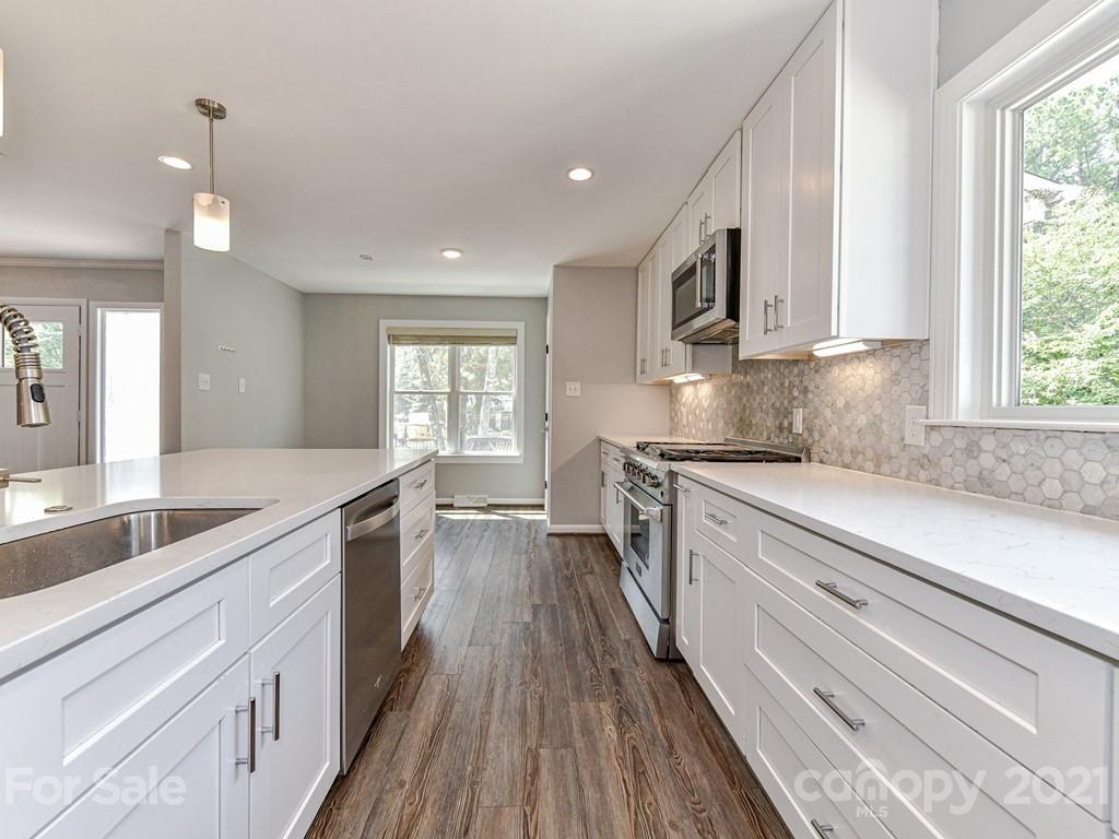 305 Boyce Road Charlotte, NC 28211 - Photo 12 of 48 a large kitchen with stainless steel appliances granite countertop a lot of counter space and a sink