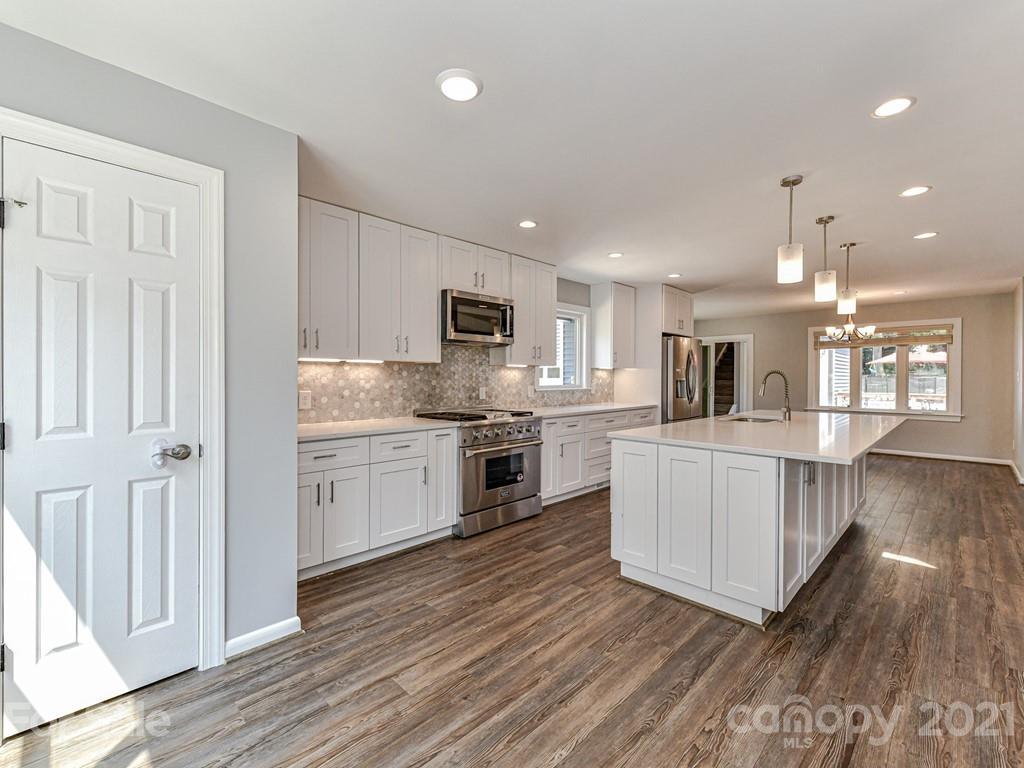 305 Boyce Road Charlotte, NC 28211 - Photo 15 of 48 a large kitchen with stainless steel appliances sink and cabinets