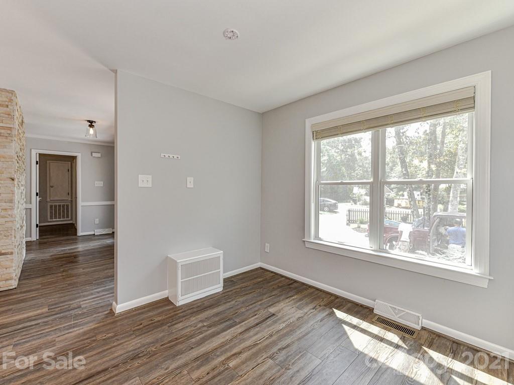 305 Boyce Road Charlotte, NC 28211 - Photo 16 of 48 a view of an empty room with wooden floor and a window