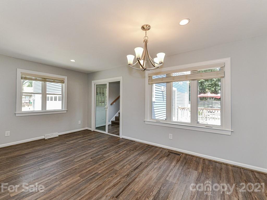 305 Boyce Road Charlotte, NC 28211 - Photo 17 of 48 an empty room with wooden floor exposed radiator and windows