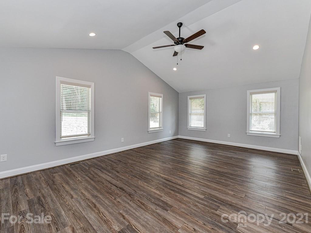 305 Boyce Road Charlotte, NC 28211 - Photo 18 of 48 a view of empty room with wooden floor and fan