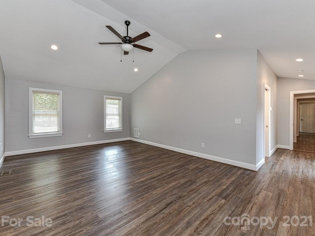 305 Boyce Road Charlotte, NC 28211 - Photo 19 of 48 an empty room with wooden floor fan and windows