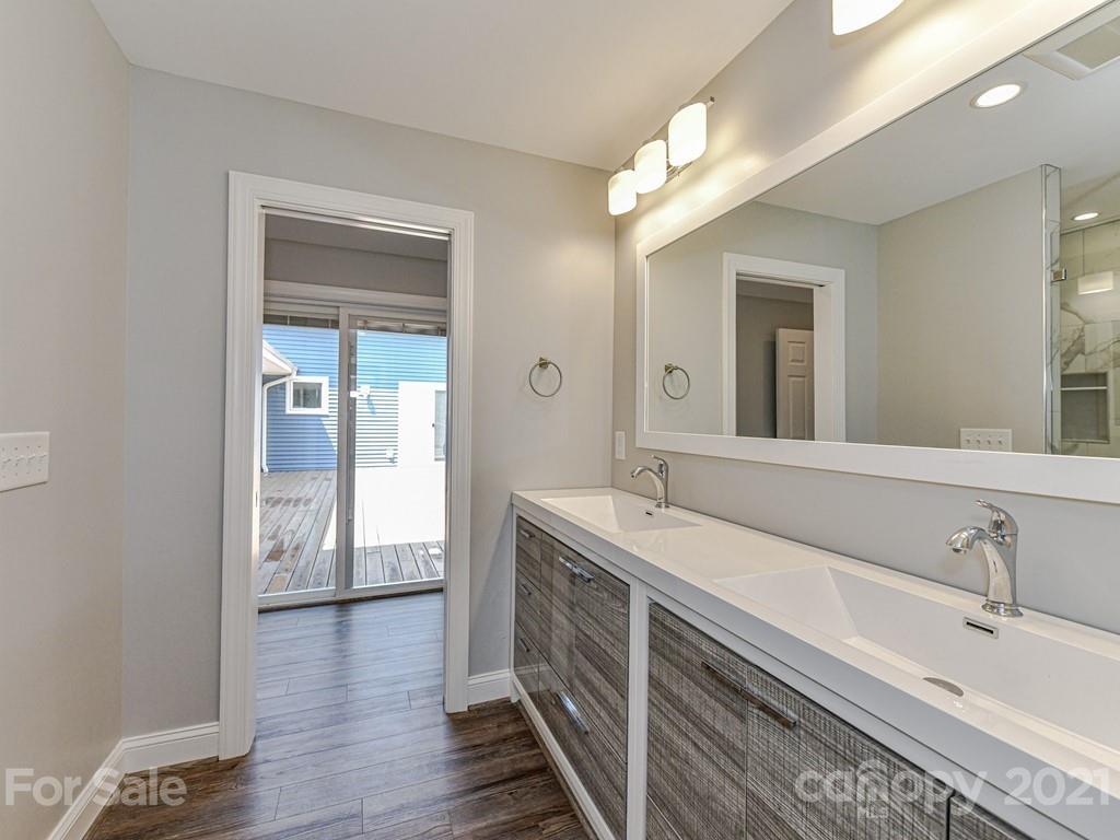 305 Boyce Road Charlotte, NC 28211 - Photo 20 of 48 a spacious bathroom with a double vanity sink and a mirror