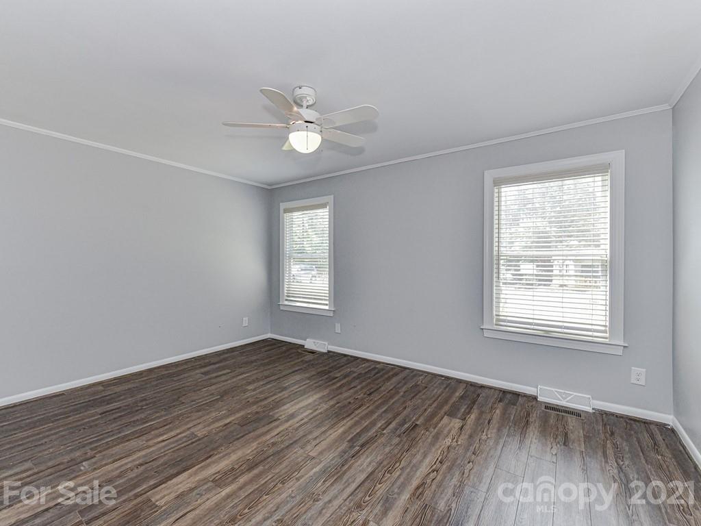 305 Boyce Road Charlotte, NC 28211 - Photo 24 of 48 a view of an empty room with wooden floor and a window