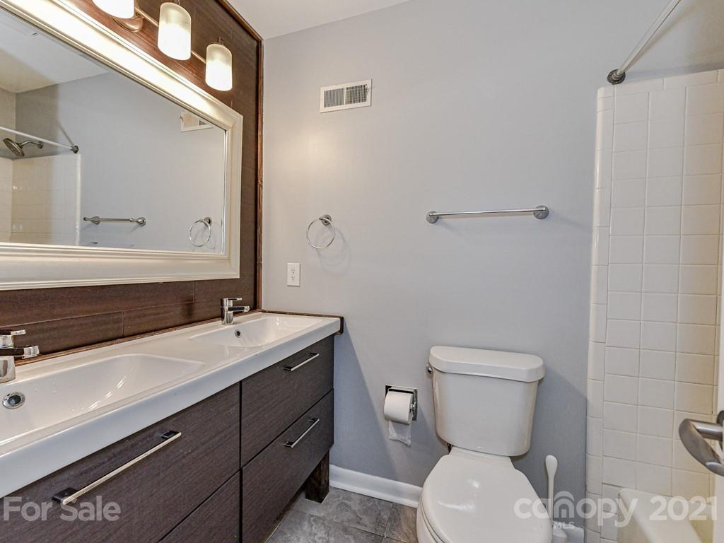 305 Boyce Road Charlotte, NC 28211 - Photo 25 of 48 a bathroom with a toilet sink and mirror