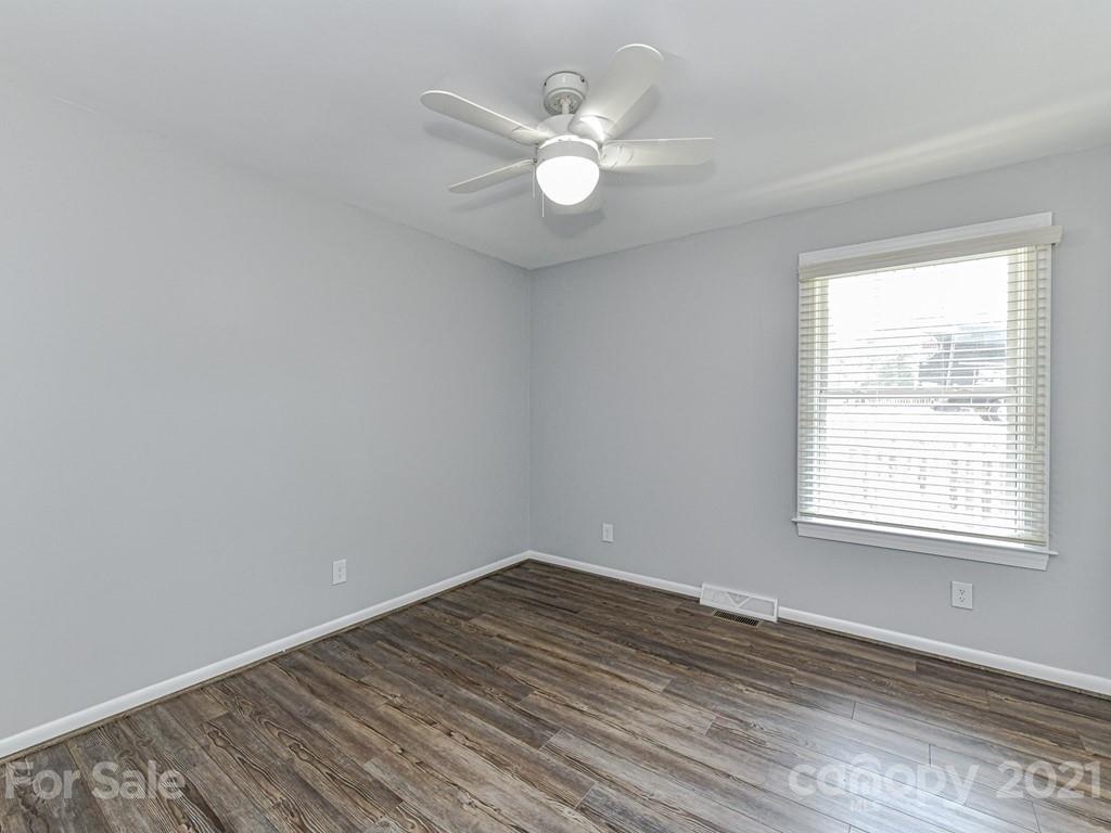 305 Boyce Road Charlotte, NC 28211 - Photo 26 of 48 an empty room with wooden floor and windows