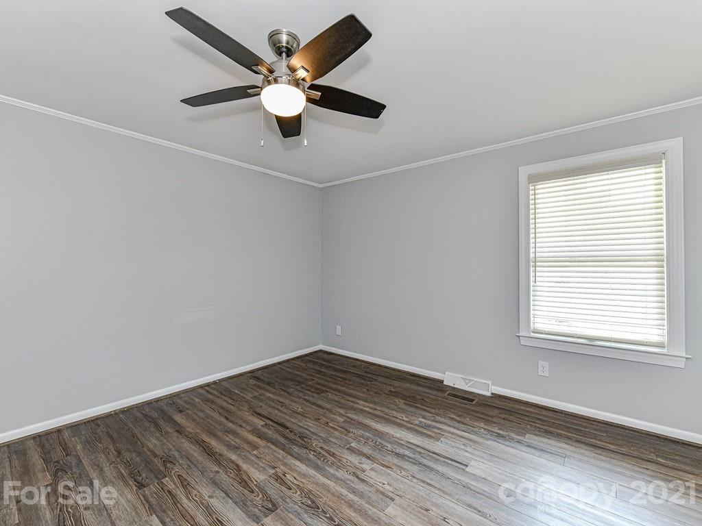 305 Boyce Road Charlotte, NC 28211 - Photo 28 of 48 an empty room with a window and a fan