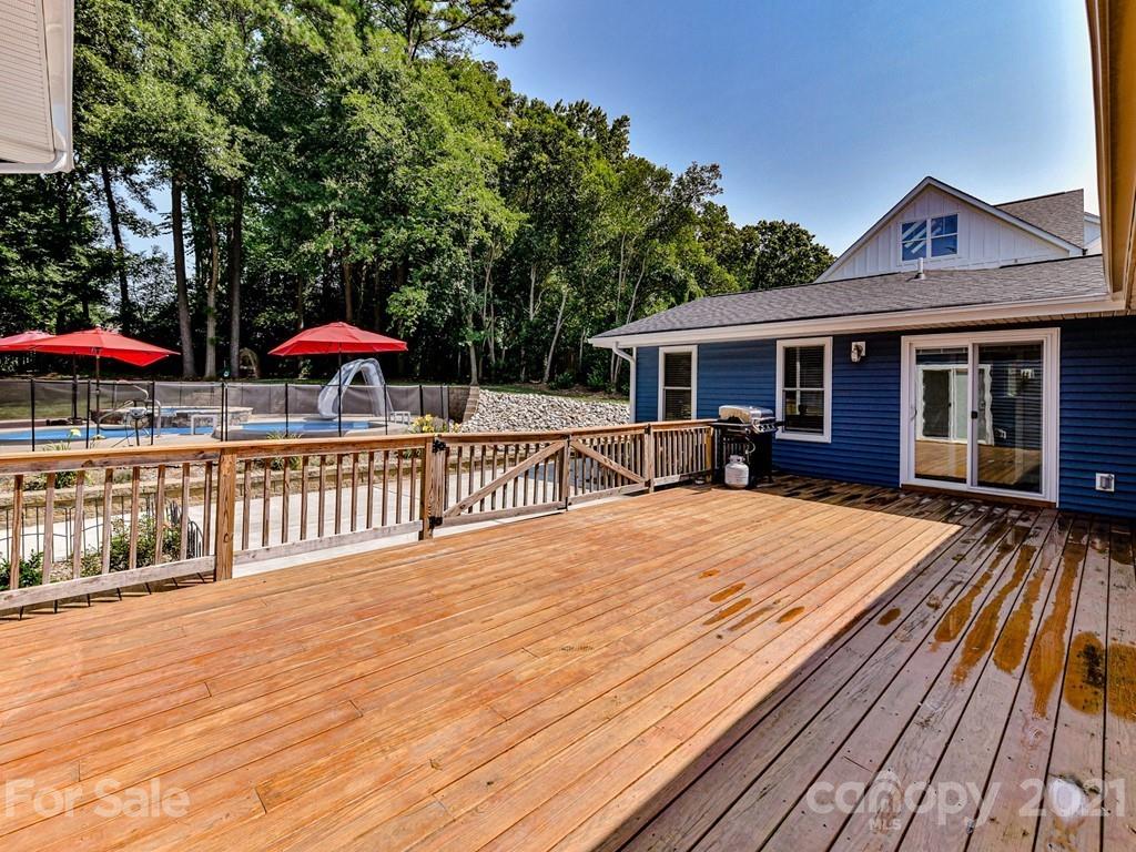 305 Boyce Road Charlotte, NC 28211 - Photo 31 of 48 a view of a house with wooden deck and a lawn chairs