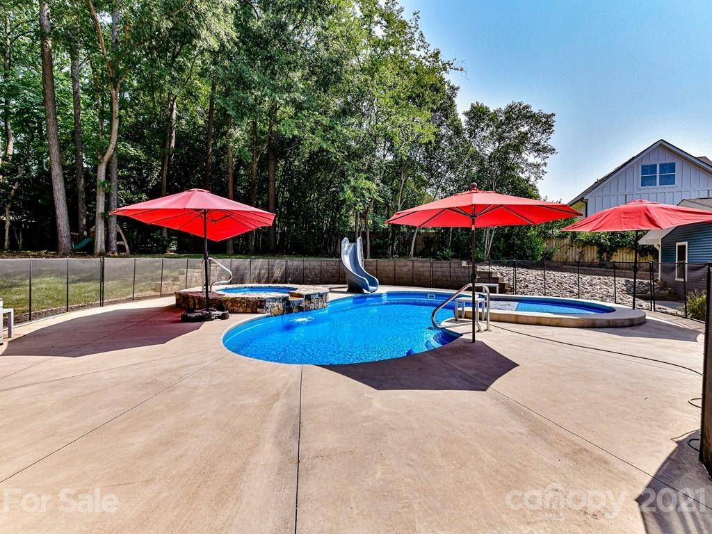 305 Boyce Road Charlotte, NC 28211 - Photo 36 of 48 an outdoor space with pool and red umbrella
