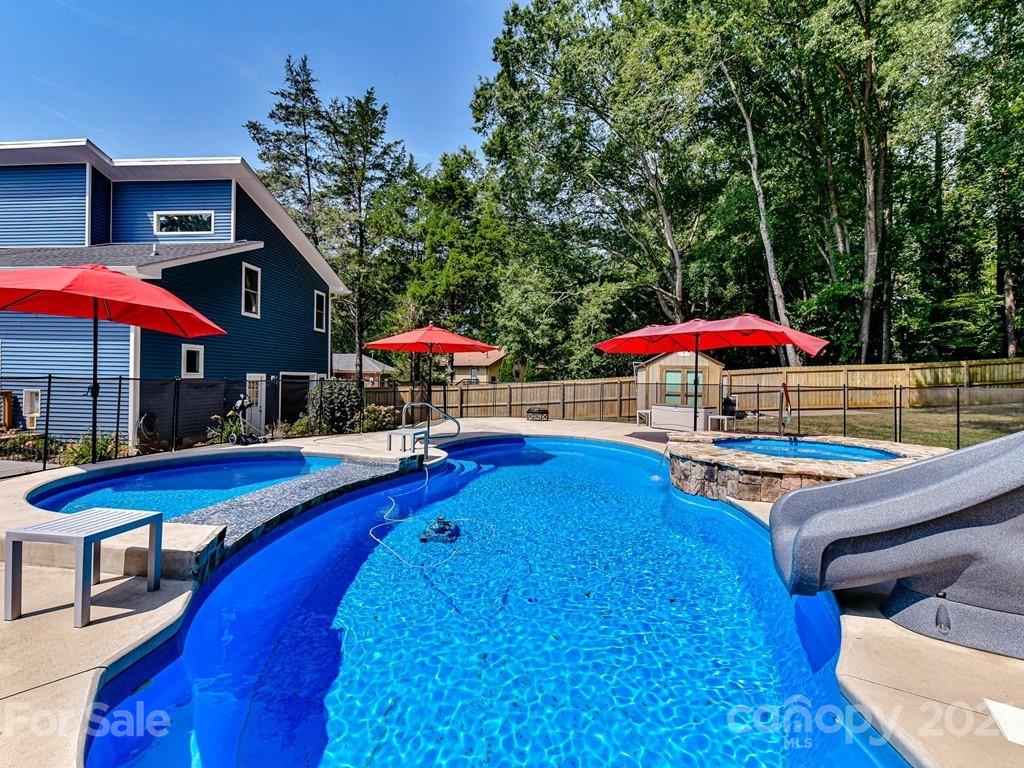 305 Boyce Road Charlotte, NC 28211 - Photo 38 of 48 a view of a backyard with swimming pool and sitting area