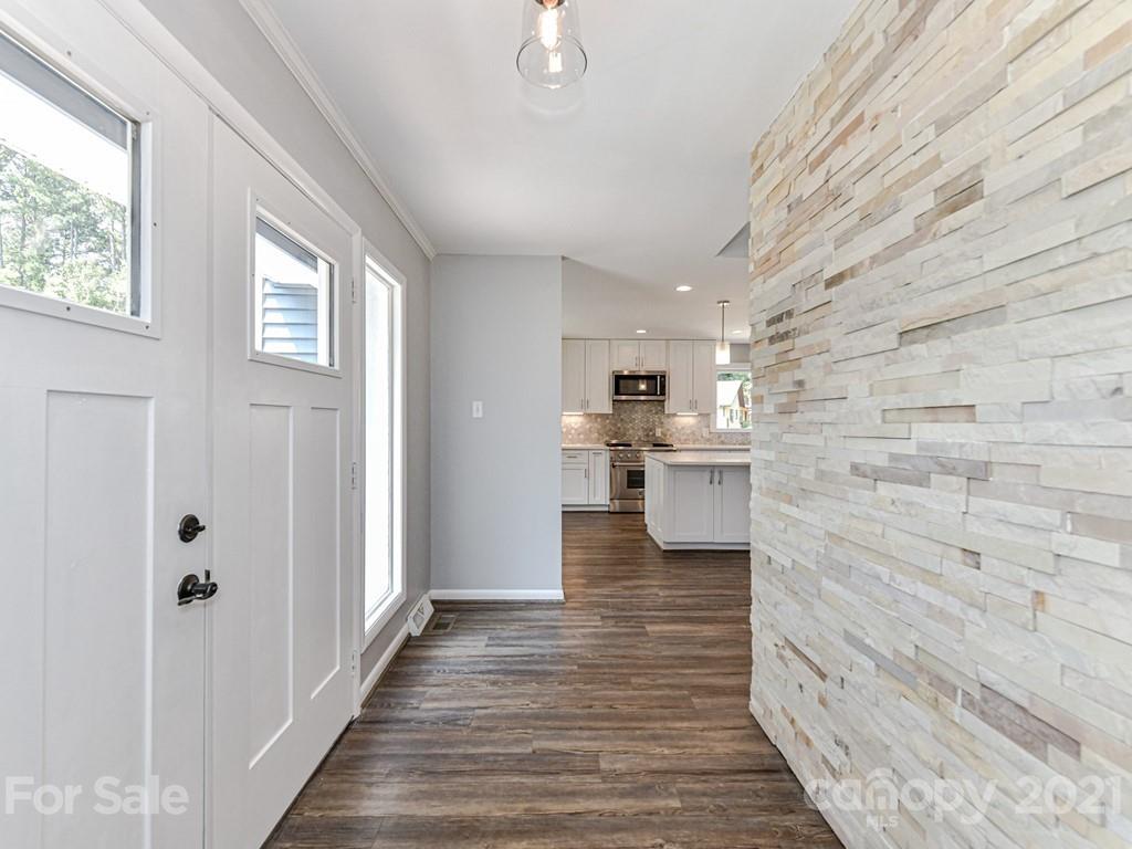 305 Boyce Road Charlotte, NC 28211 - Photo 5 of 48 a view of a hallway with wooden floor and staircase