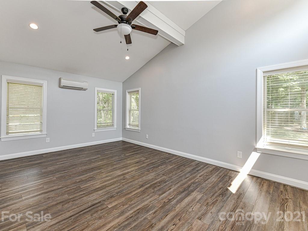 305 Boyce Road Charlotte, NC 28211 - Photo 41 of 48 a view of an empty room with wooden floor and a window