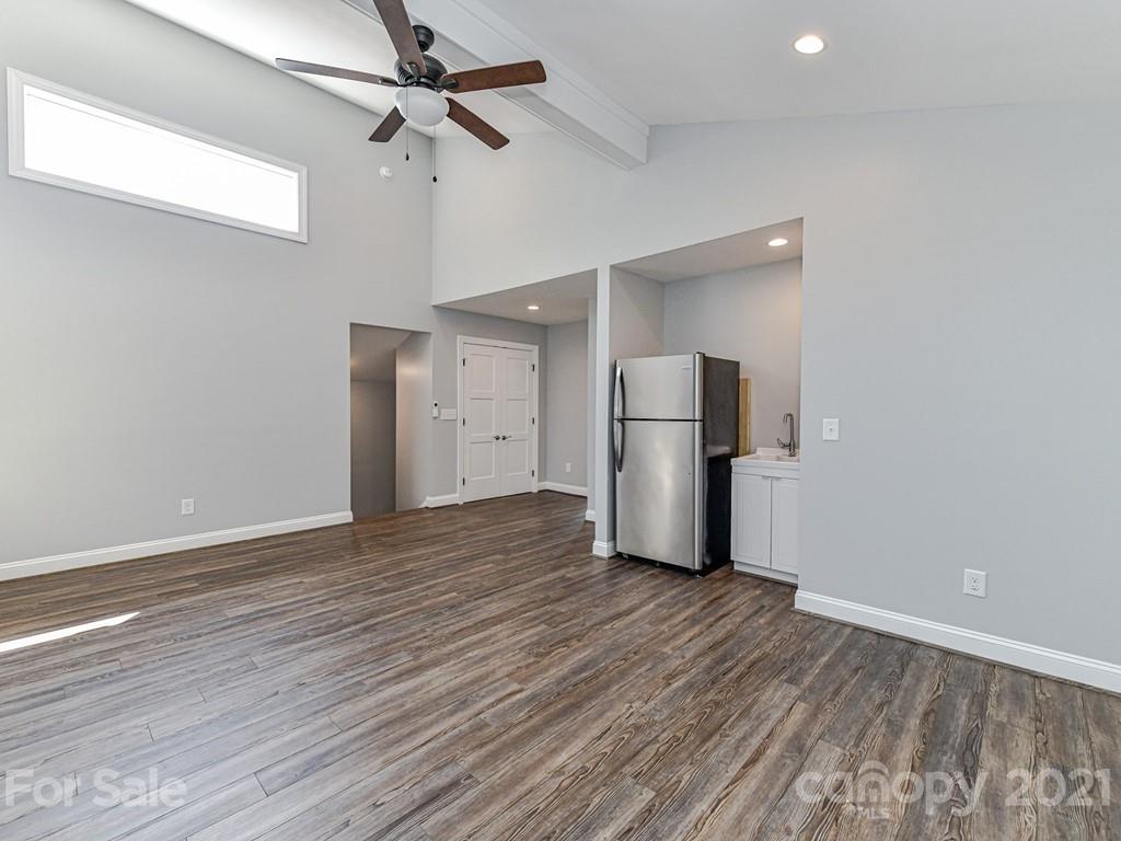 305 Boyce Road Charlotte, NC 28211 - Photo 42 of 48 a view of a livingroom with wooden floor and a ceiling fan