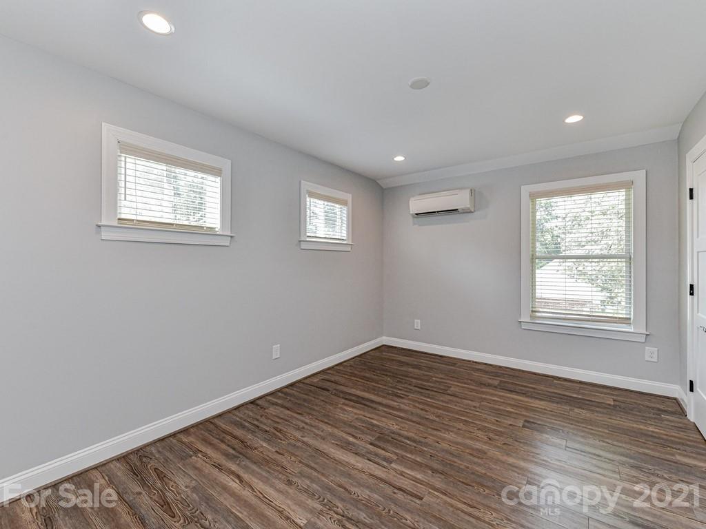 305 Boyce Road Charlotte, NC 28211 - Photo 43 of 48 a view of an empty room with wooden floor and a window