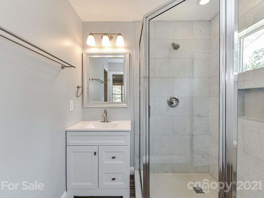 305 Boyce Road Charlotte, NC 28211 - Photo 44 of 48 a bathroom with a sink a toilet and shower