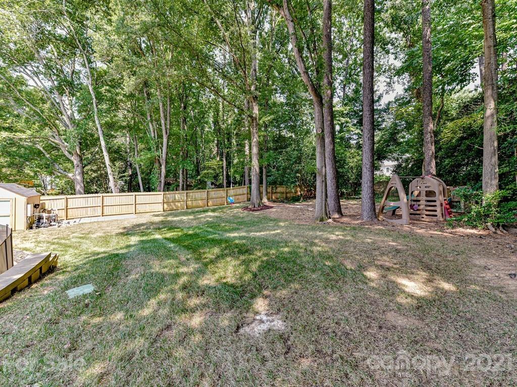 305 Boyce Road Charlotte, NC 28211 - Photo 45 of 48 a view of outdoor space with deck and trees