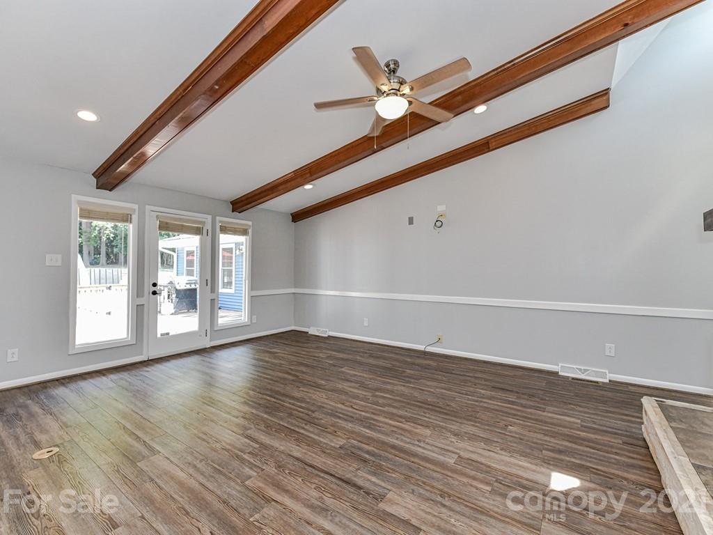 305 Boyce Road Charlotte, NC 28211 - Photo 6 of 48 a view of an empty room with wooden floor and a window