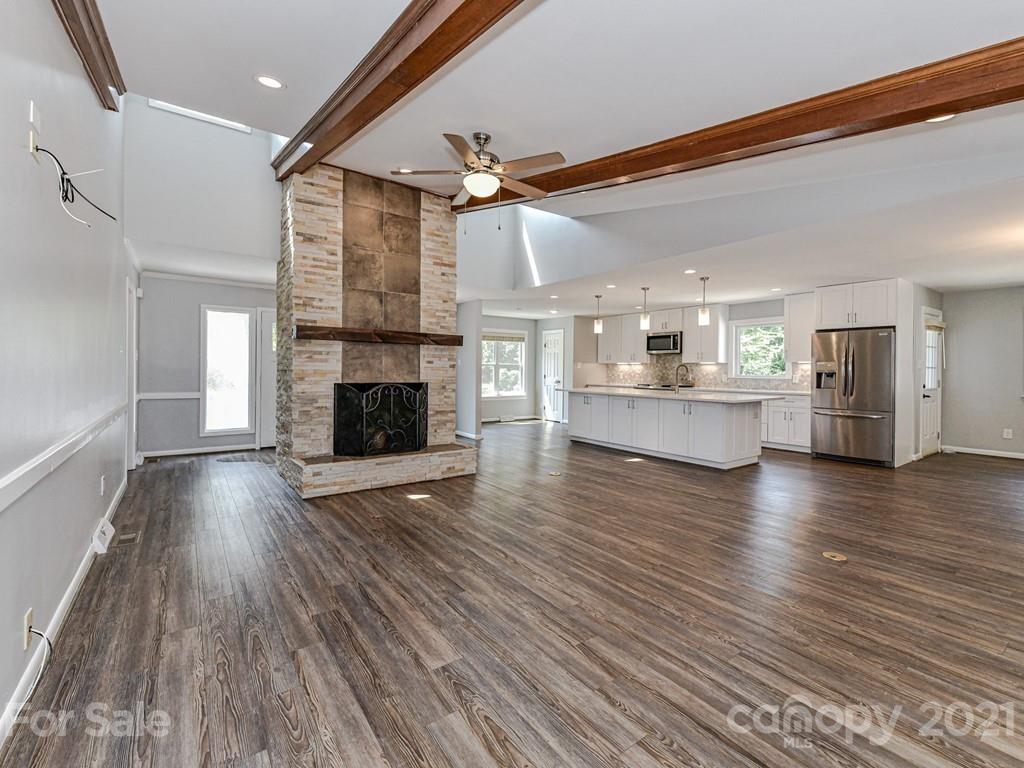 305 Boyce Road Charlotte, NC 28211 - Photo 7 of 48 a view of a kitchen with a dishwasher a kitchen wooden floor and a kitchen