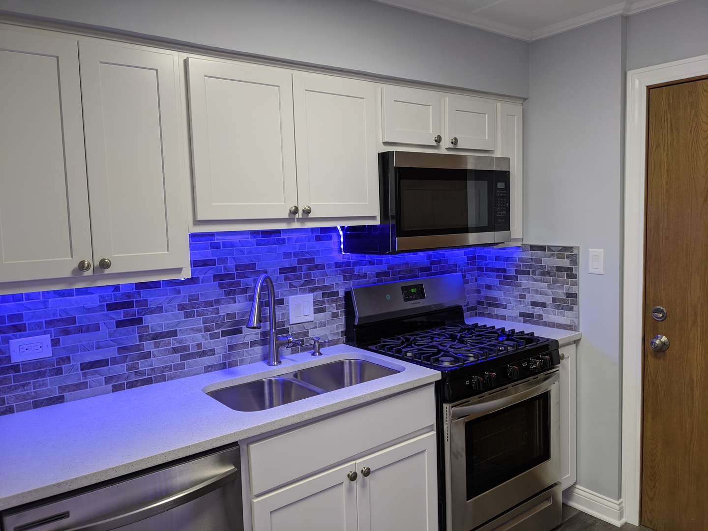10440 South Ridgeland Avenue, Unit 5 Chicago Ridge, IL 60415 - Photo 13 of 27 a kitchen with stainless steel appliances granite countertop a stove a microwave and cabinets