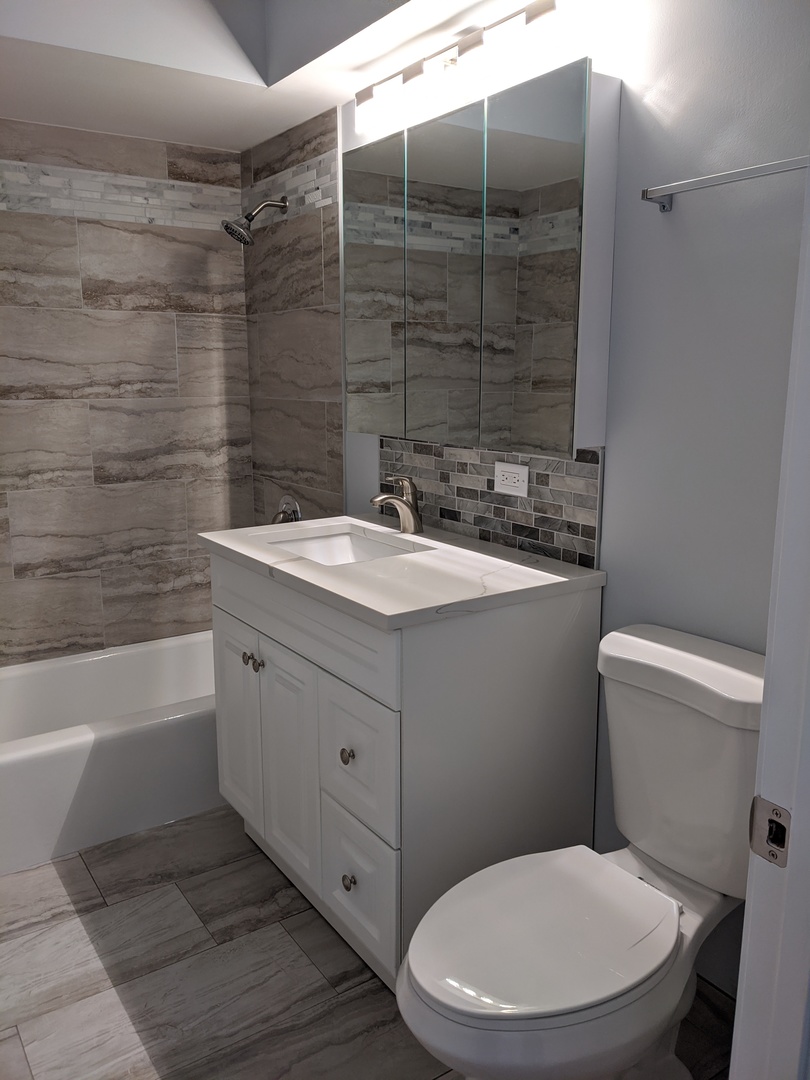 10440 South Ridgeland Avenue, Unit 5 Chicago Ridge, IL 60415 - Photo 19 of 27 a bathroom with a sink a toilet and shower