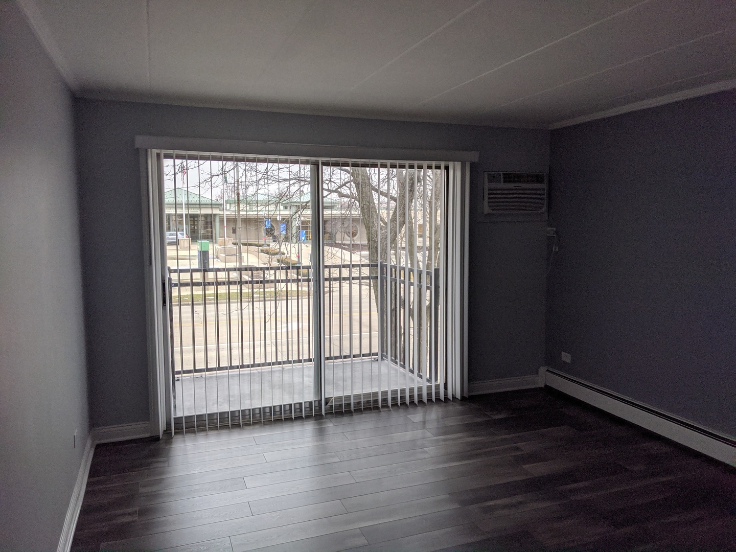 10440 South Ridgeland Avenue, Unit 5 Chicago Ridge, IL 60415 - Photo 5 of 27 wooden floor in an empty room with a window